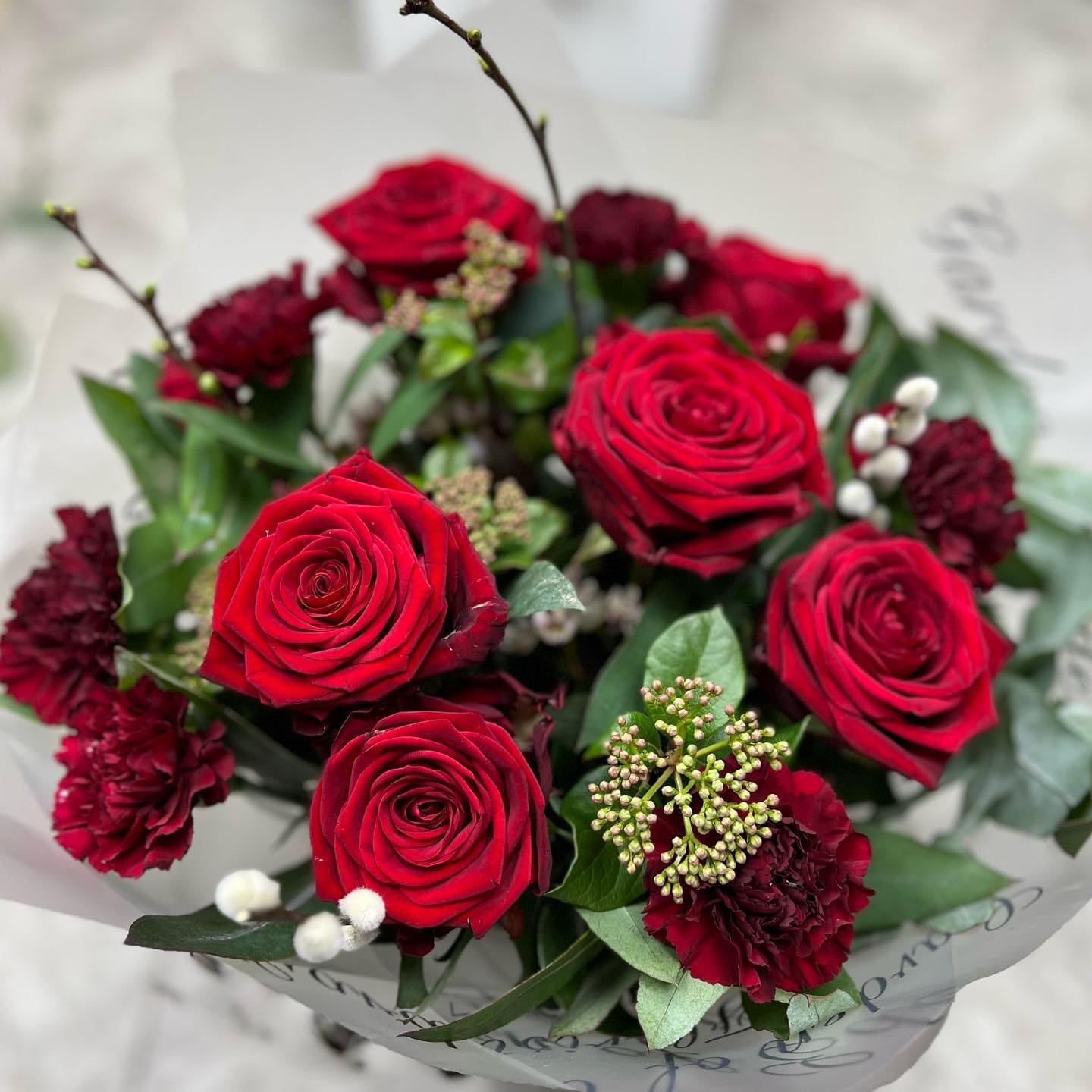 Bouquet of bright red roses with green foliage