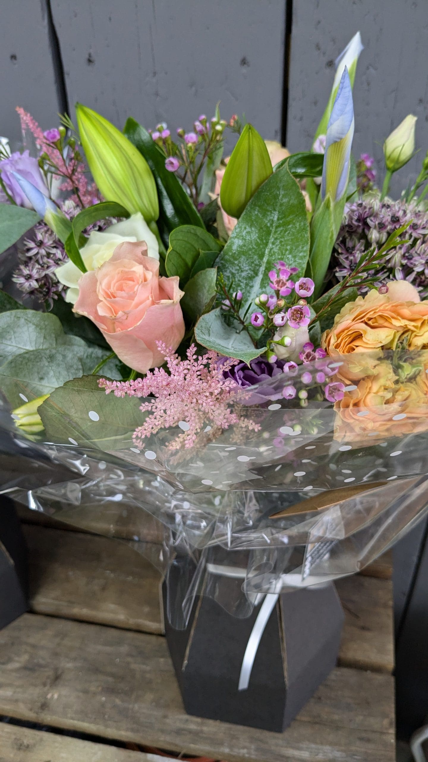 florist choice bouquet of flowers with pink, purple and orange colours, lilies and foliage