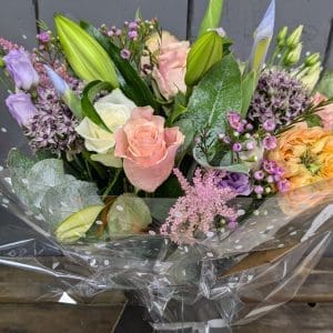 florist choice bouquet of flowers with pink, purple and orange colours, lilies and foliage