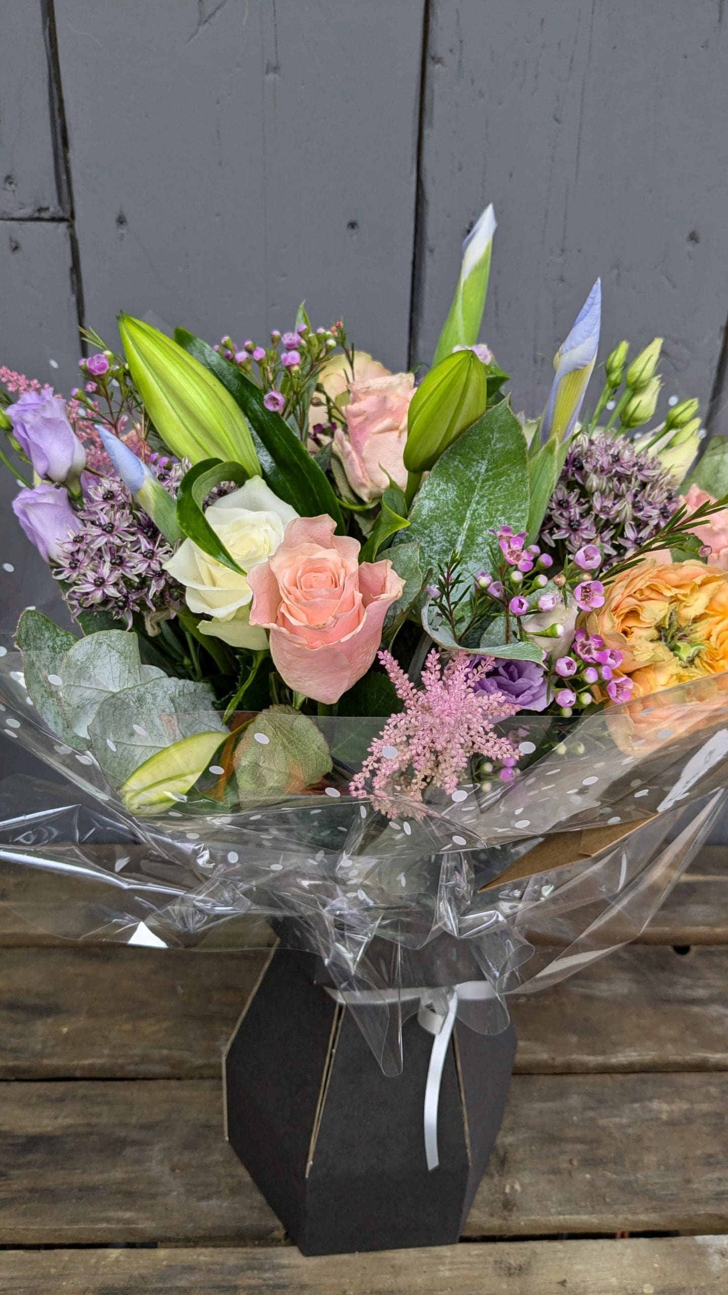 florist choice bouquet of flowers with pink, purple and orange colours, lilies and foliage
