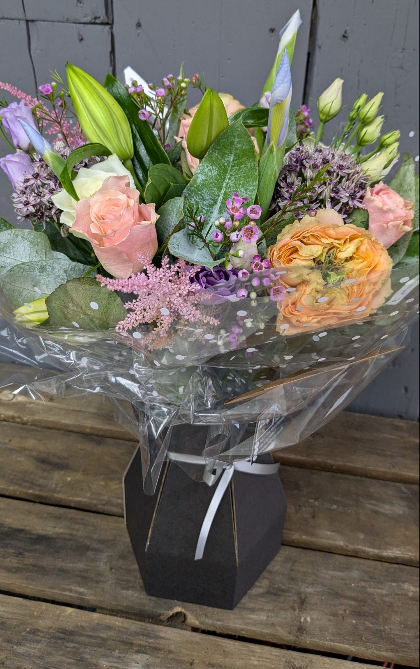 florist choice bouquet of flowers with pink, purple and orange colours, lilies and foliage
