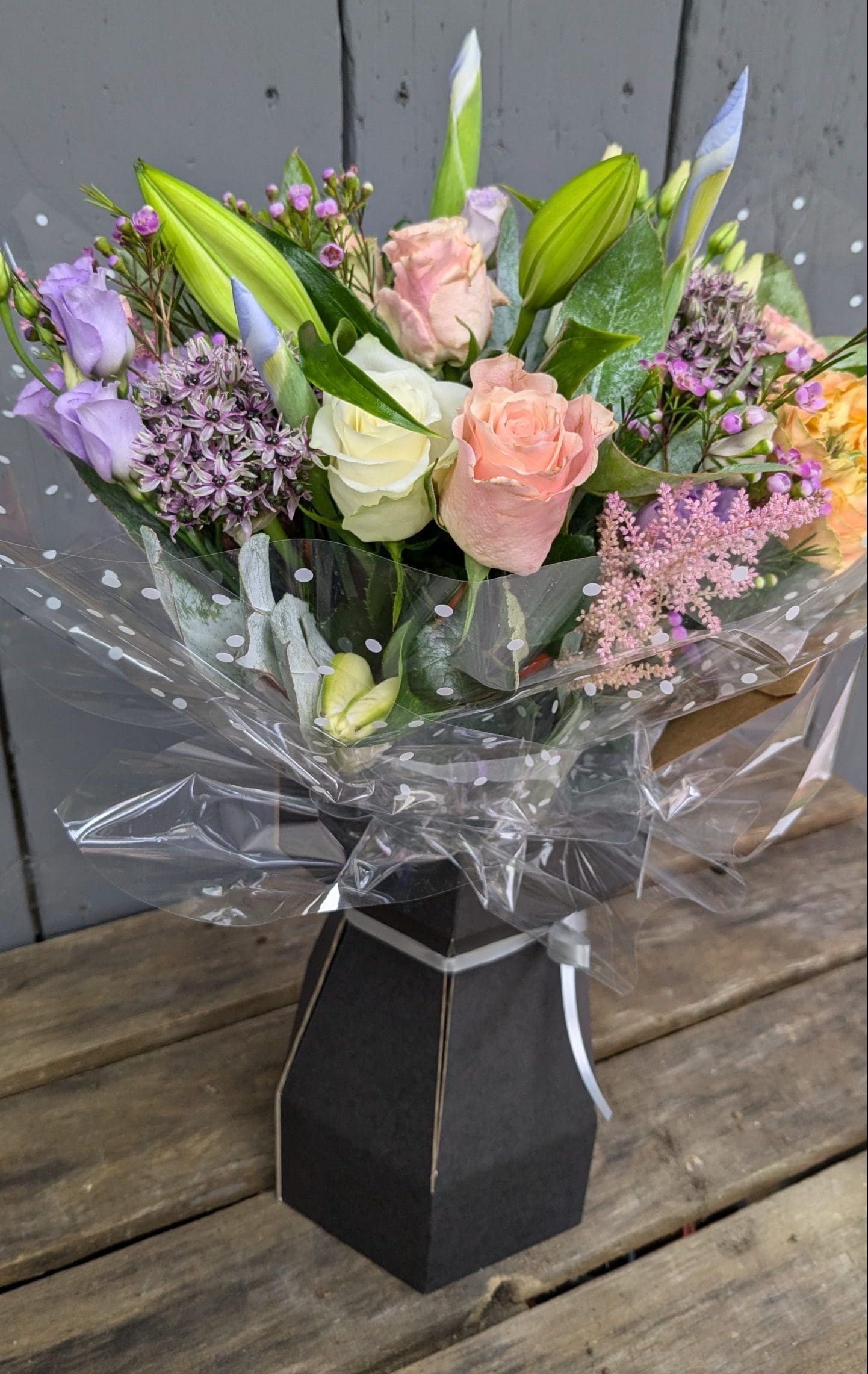 florist choice bouquet of flowers with pink, purple and orange colours, lilies and foliage