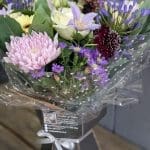 A bouquet of pink and lilac coloured flowers from the side